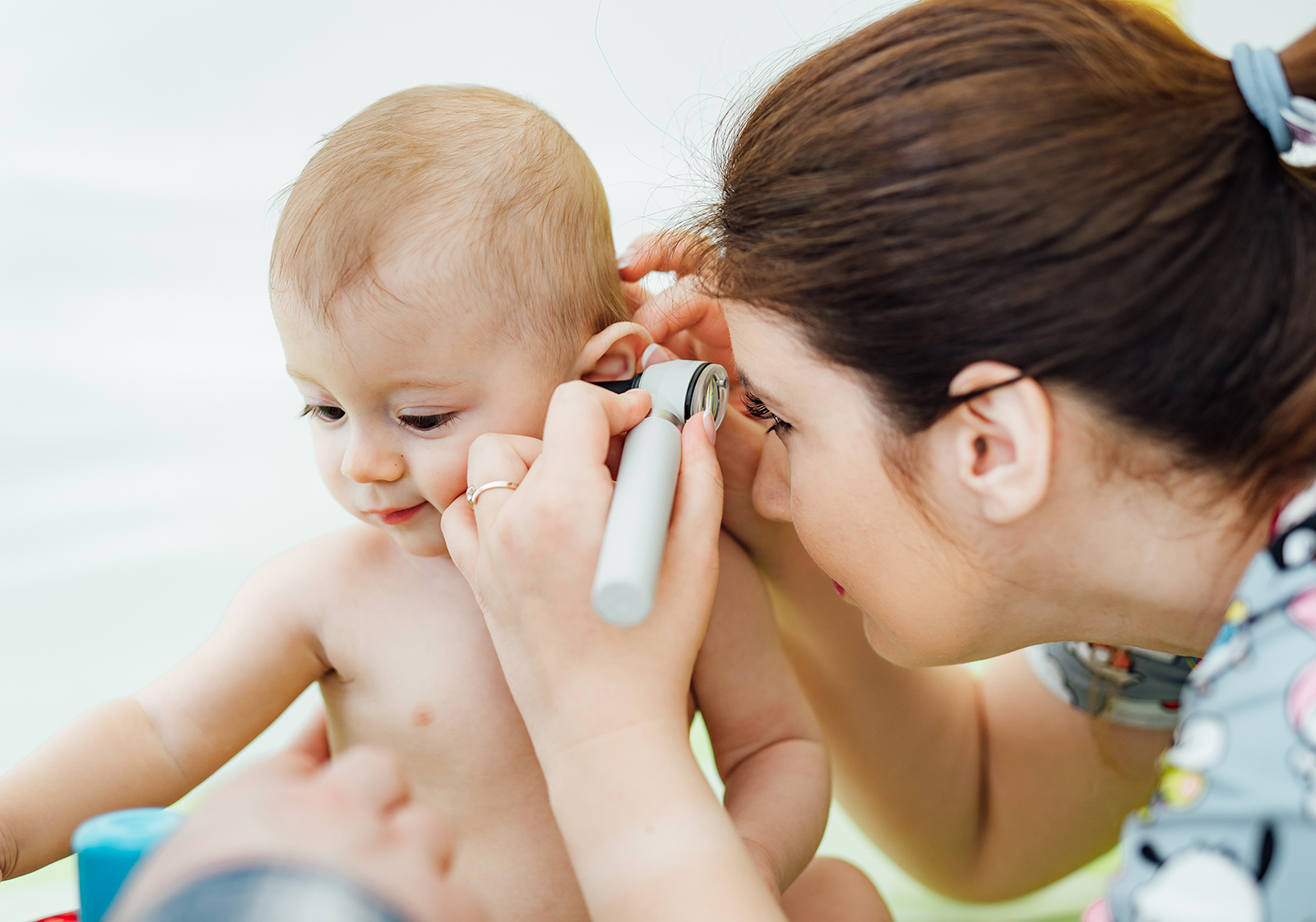 Doctor checking babys ear