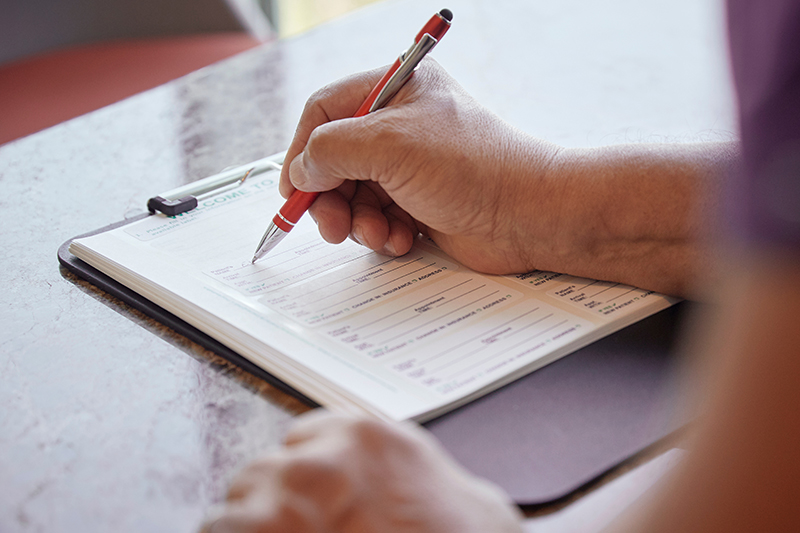 a person filling out Medical Registration forms